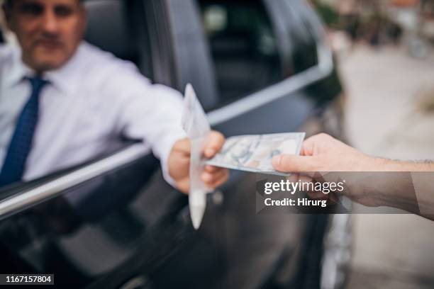 man buying cocaine from drug dealer - recreational drug stock pictures, royalty-free photos & images