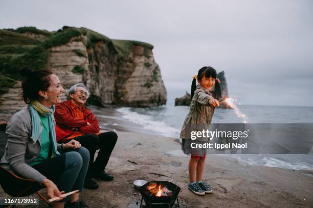 young girl having fun with fireworks by the sea, chiba, japan - multi generation family candid stock pictures, royalty-free photos & images