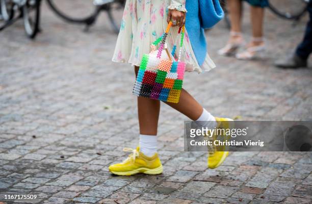 Guest is seen wearing multi colored bag, yellow Chanel sneaker outside Saks Potts during Copenhagen Fashion Week Spring/Summer 2020 on August 08,...