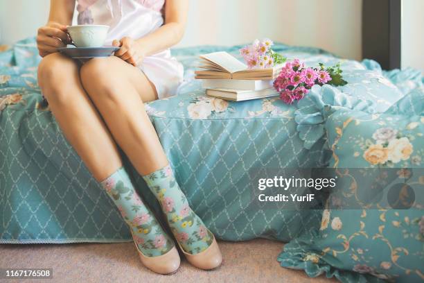 woman having tea on bed - pump dress shoe ストックフォトと画像