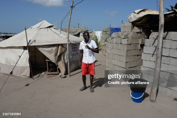 September 2019, Mozambique, Beira: Joao Deluis, the leader of a tent camp near the city of Beira, stands in front of his tent. The 31-year-old and...