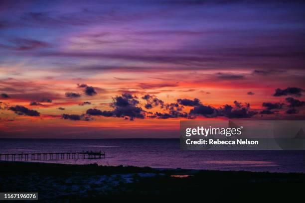 dramatic sunset over mobile bay - mobile alabama stock pictures, royalty-free photos & images