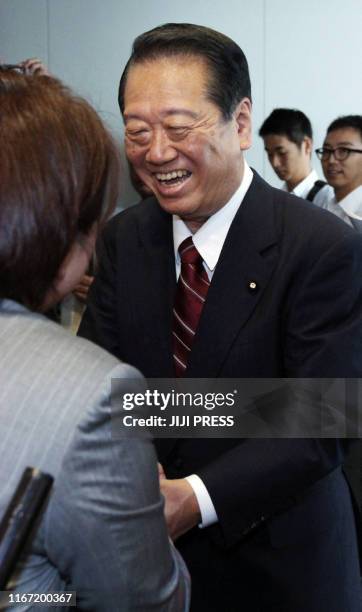 Ichiro Ozawa shakes the hands of supporters during his election campaign for DPJ lawmakers in Tokyo on September 13 one day before of the DPJ...