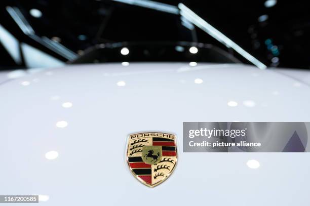 September 2019, Hessen, Frankfurt/Main: A Porsche logo can be seen on the bonnet of a Porsche Cayenne Turbo S E-Hybrid Coupe at the IAA. Photo: Silas...