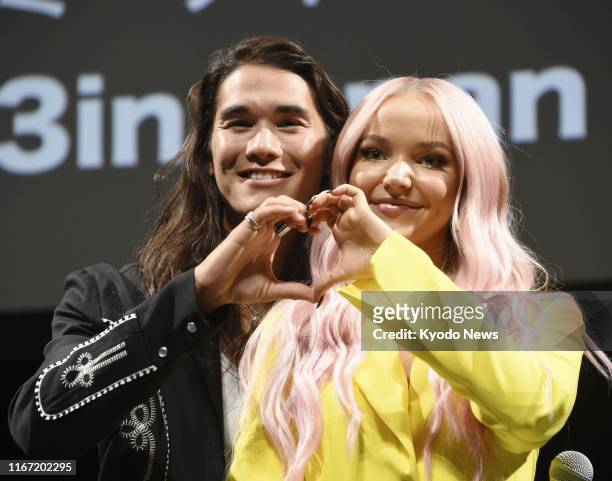 Dove Cameron and Booboo Stewart pose for a photo in Tokyo to promote their Disney channel movie "Descendants 3" on Sept. 9, 2019.