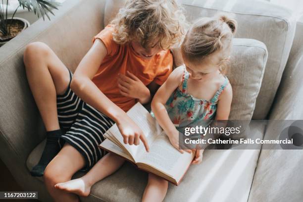 reading a book - storytelling stock pictures, royalty-free photos & images