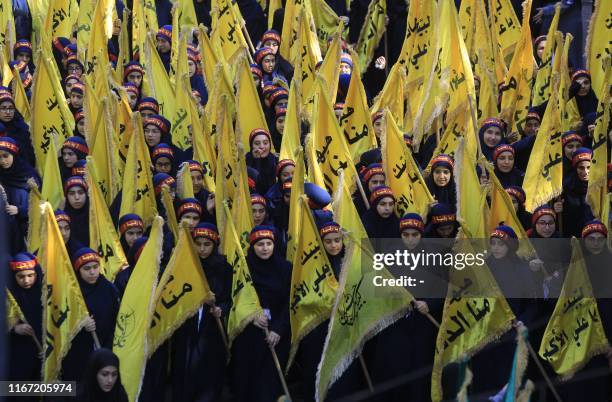 Supporters of the Lebanese Shiite Hezbollah movement take part in a mourning procession on the tenth day of the lunar month of Muharram, which marks...
