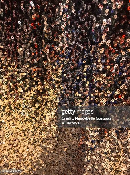 gold, black, brown, and orange coloured sequined fabric swatch. - black sequin dress stock pictures, royalty-free photos & images