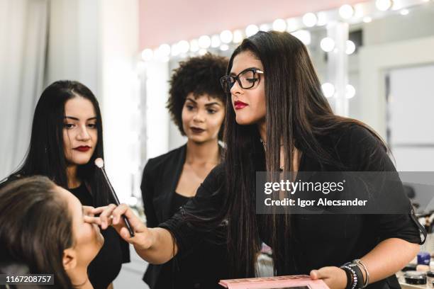 makeup artist in her studio during training - beautician stock pictures, royalty-free photos & images