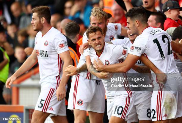 Billy Sharp of Sheffield United celebrates with teammates after scoring his team's first goal during the Premier League match between AFC Bournemouth...
