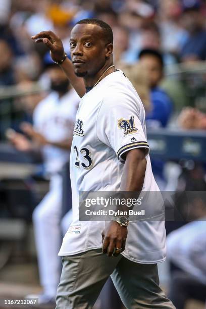 Former Milwaukee Brewers player Rickie Weeks waves to the crowd during a pregame ceremony before the game between the Texas Rangers and Milwaukee...