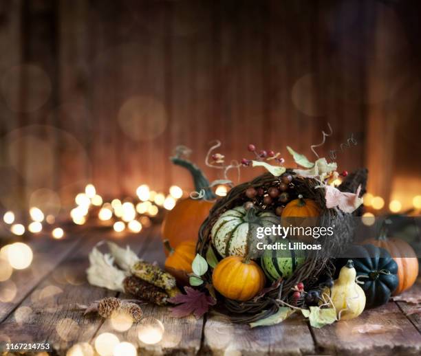 autumn thanksgiving cornucopia on a wood background - thanksgiving arrangement stock pictures, royalty-free photos & images