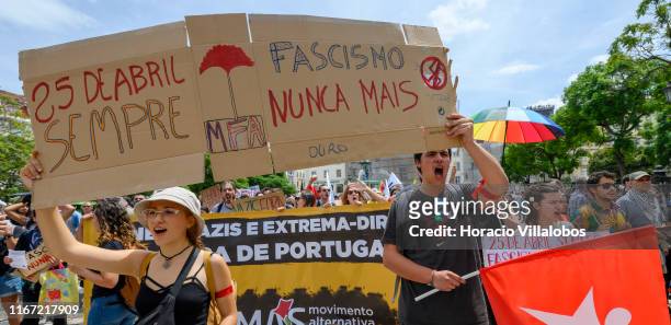 Demonstrators hold signs in a national anti-fascist rally from Rossio Square to Praça Camoes on August 10, 2019 in Lisbon, Portugal. Hundreds of...