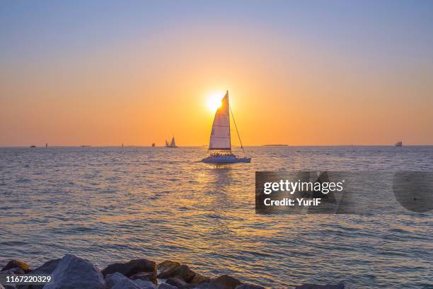 yacht and sunset - key west stock-fotos und bilder