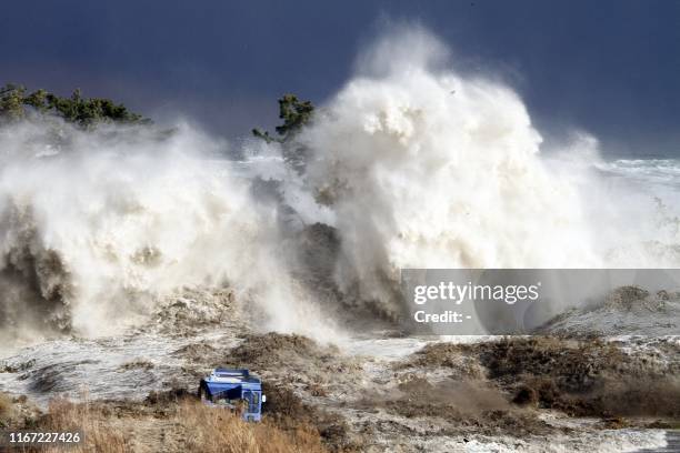 This picture taken on March 11, 2011 by Sadatsugu Tomizawa and released via Jiji Press on March 21, 2011 shows tsunami waves hitting the coast of...