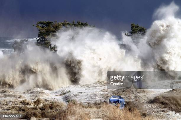 This picture taken on March 11, 2011 by Sadatsugu Tomizawa and released via Jiji Press on March 21, 2011 shows tsunami waves hitting the coast of...
