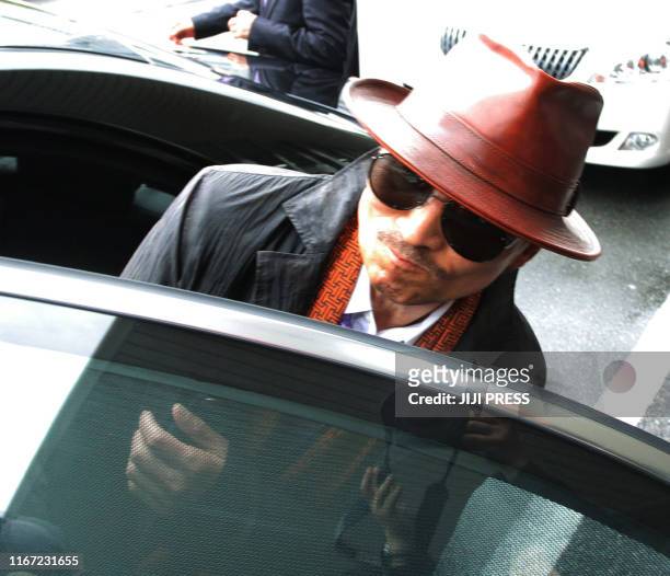 Kenichi Shinoda, the boss of Japan's largest "yakuza" gang, the Yamaguchi-gumi, gets into a car after arriving at the train station in Kobe, western...