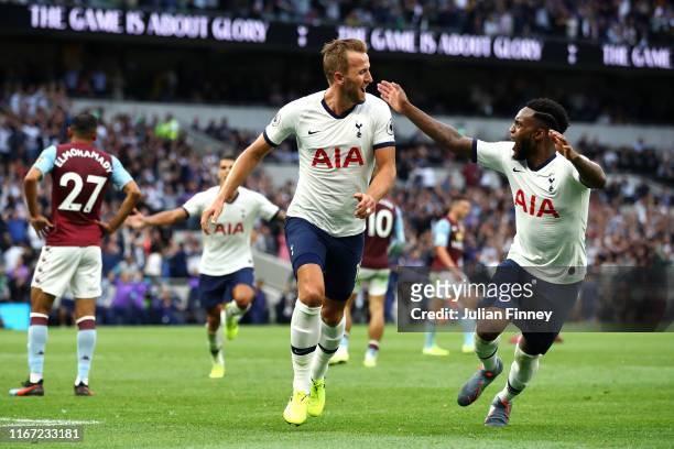Harry Kane of Tottenham Hotspur celebrates with teammate Danny Rose after scoring his team's second goal during the Premier League match between...