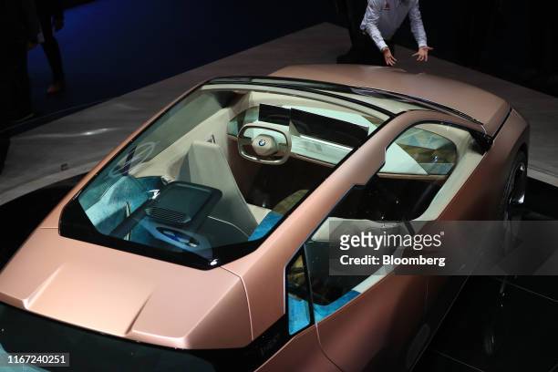 The sunroof exposes the interior of a BMW Vision i Next luxury electric concept automobile, manufactured by Bayerische Motoren Werke AG, on the...