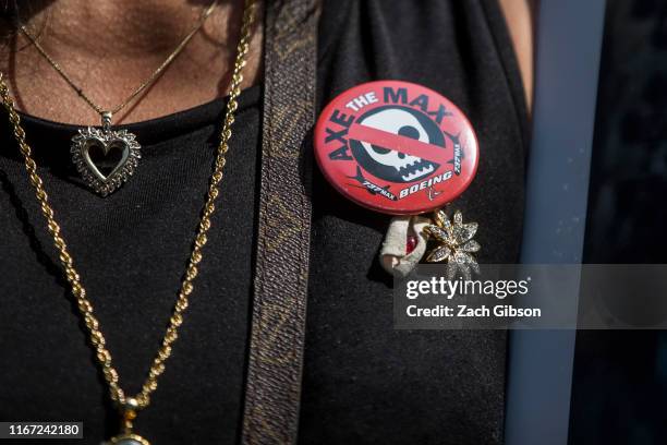 Clariss Moore wears a button calling for the Boeing 737 MAX 8 to be grounded during a vigil for victims of the Ethiopian Airlines Flight ET302 crash...