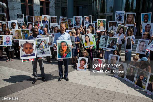 People hold signs during a vigil for victims of the Ethiopian Airlines Flight ET302 crash on September 10, 2019 in Washington, DC. The March 10, 2019...