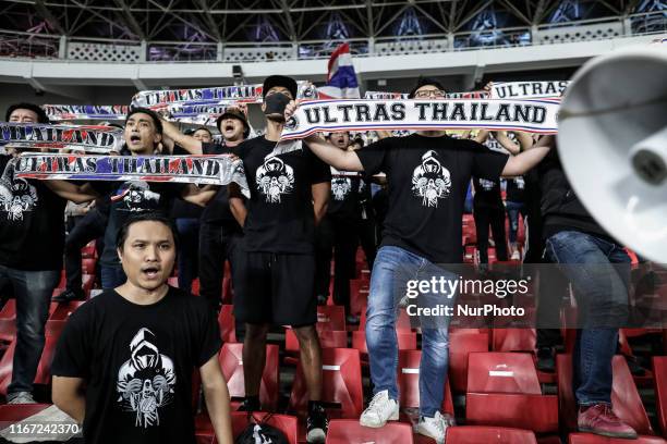 Thailand's fans shout slogans during FIFA World Cup 2022 qualifying match between Indonesia and Thailand at the Gelora Bung Karno stadium in Jakarta,...