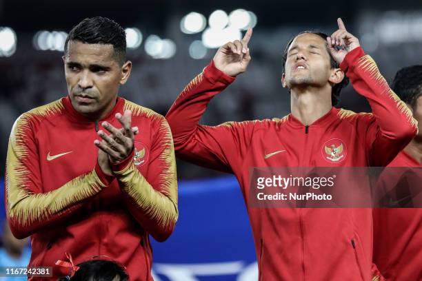 Indonesian's Beto Goncalves and Irfan Bachdim sing National Anthem during FIFA World Cup 2022 qualifying match between Indonesia and Thailand at the...