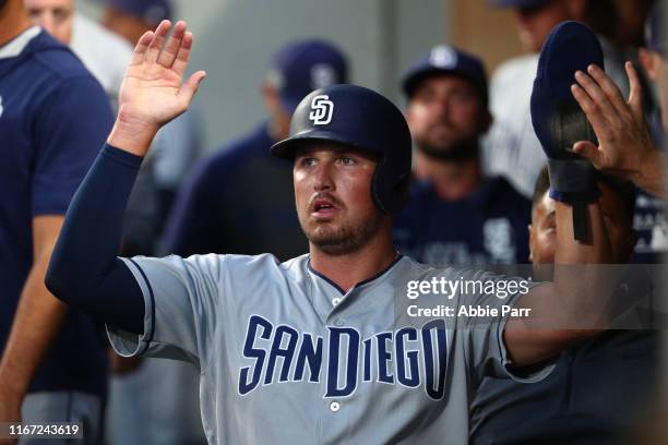 Rod Barajas celebrates in the dugout after scoring off an RBI double from Manuel Margot of the San Diego Padres in the fifth inning against the...