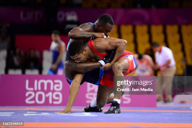 Julio Rodriguez of Dominican Republic and Geandry Garzon of Cuba compete during Wrestling Men's Freestyle 74kg on Day 15 of Lima 2019 Pan American...