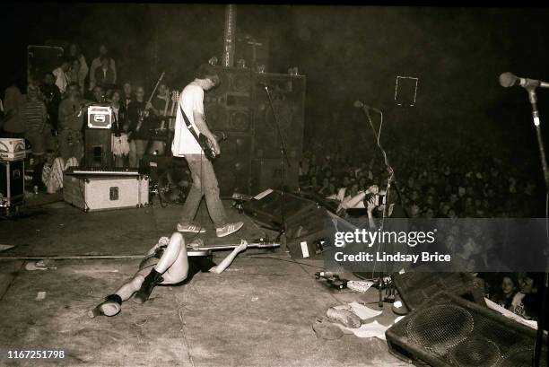 Bassist and vocalist Kim Gordon continues to play bass while on her back on stage with guitarist and vocalist Thurston Moore, guitarist Lee Renaldo,...