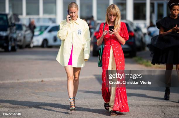Thora Valdimars wearing yellow button shirt and Jeanette Madsen wearing red button up dress, yellow pants seen outside Cecilie Bahnsen during...