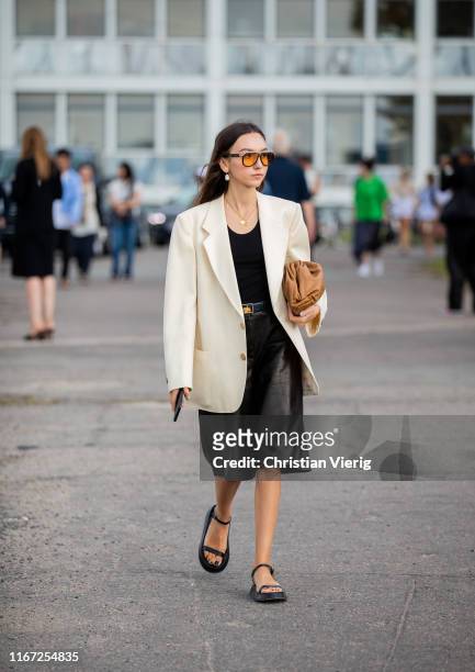 Beatrice Gutu is seen wearing creme white blazer, black leather skirt outside Cecilie Bahnsen during Copenhagen Fashion Week Spring/Summer 2020 on...