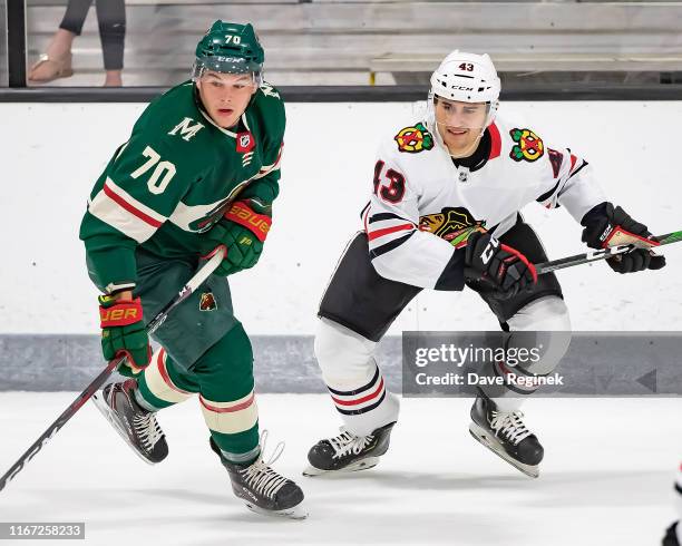 Drake Pilon of the Minnesota Wild follows the play next to Chad Krys of the Chicago Blackhawks during Day-5 of the NHL Prospects Tournament at Centre...