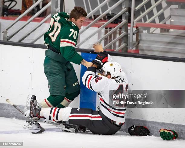 Drake Pilon of the Minnesota Wild fights with Riley McKay of the Chicago Blackhawks during Day-5 of the NHL Prospects Tournament at Centre Ice Arena...