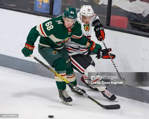 Will Bitten of the Minnesota Wild battles for the puck with Jake Ryczek of the Chicago Blackhawks during Day-5 of the NHL Prospects Tournament at...