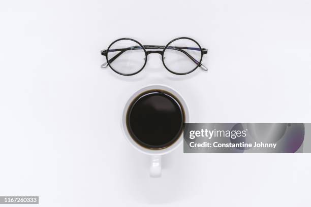 cup of coffee and eyeglasses on white desk - coffee still life stock pictures, royalty-free photos & images