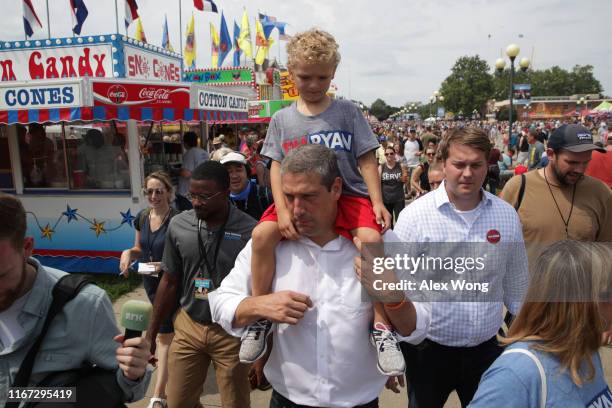 Five-year-old Brady Ryan, son of Democratic presidential candidate U.S. Rep. Tim Ryan , rides on his shoulders after he delivered a campaign speech...