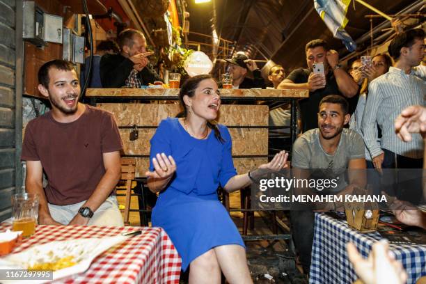 Ayelet Shaked , chairwoman of Israel's United Right party, talks with youths while on an election campaign tour at the Mahane Yehuda market in...