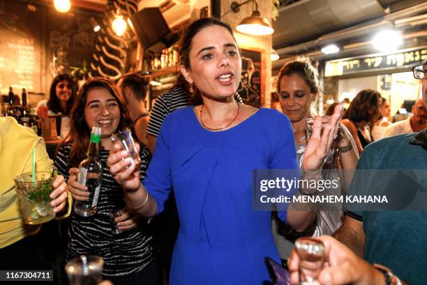 Ayelet Shaked , chairwoman of Israel's United Right party, toasts with youths while on an election campaign tour at the Mahane Yehuda market in...