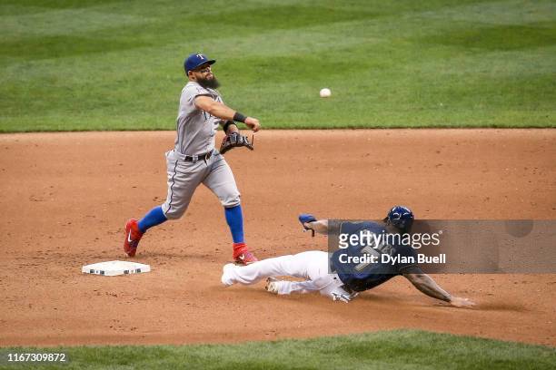 Rougned Odor of the Texas Rangers turns a double play past Eric Thames of the Milwaukee Brewers in the fifth inning at Miller Park on August 10, 2019...
