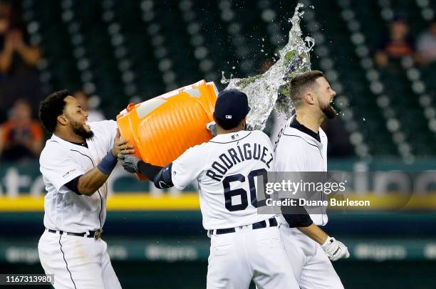 Jordy Mercer of the Detroit Tigers is doused with water by Dawel Lugo and Ronny Rodriguez after hitting a single to drive in Willi Castro and defeat...