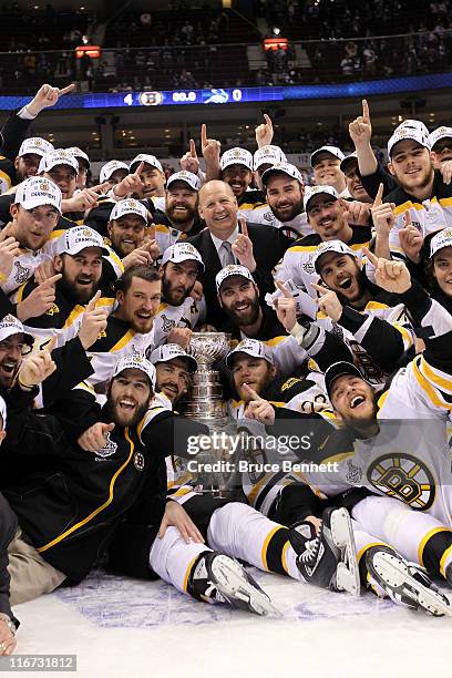 The Boston Bruins pose with the Stanley Cup after defeating the Vancouver Canucks in Game Seven of the 2011 NHL Stanley Cup Final at Rogers Arena on...