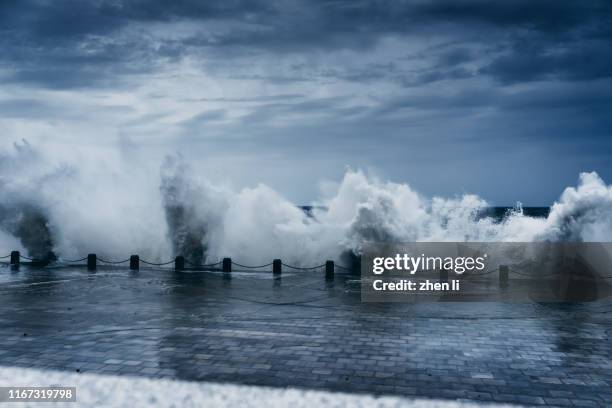 the storm whipped up powerful waves - cyclone stock pictures, royalty-free photos & images