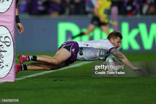 Cameron Munster of the Melbourne Storm scores a try during the round 21 NRL match between the South Sydney Rabbitohs and the Melbourne Storm at...