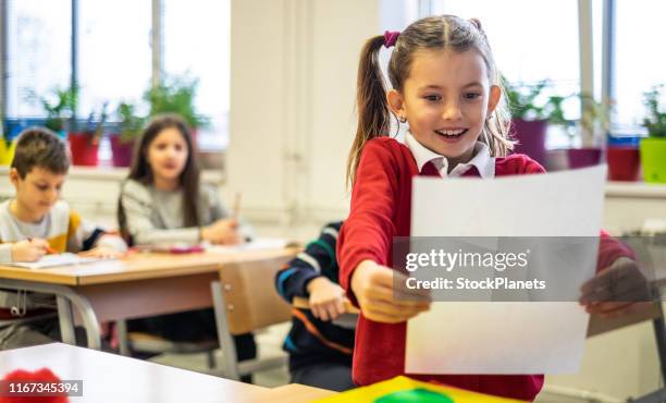 happy schoolgirl because get a high grade - child report card stock pictures, royalty-free photos & images