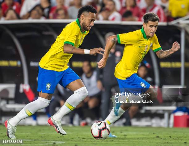 Neymar and Philippe Coutinho of Brazil attack during the 2019 International Champions Cup at the Los Angeles Coliseum between Brazil and Peru on...