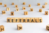referrals - word from wooden blocks with letters