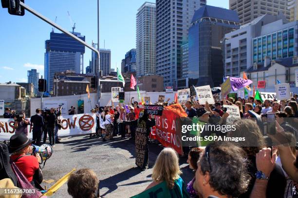 Protesters and media gather at the intersection near a major inner city byway during the Extinction Rebellion demonstration. Members of the public...