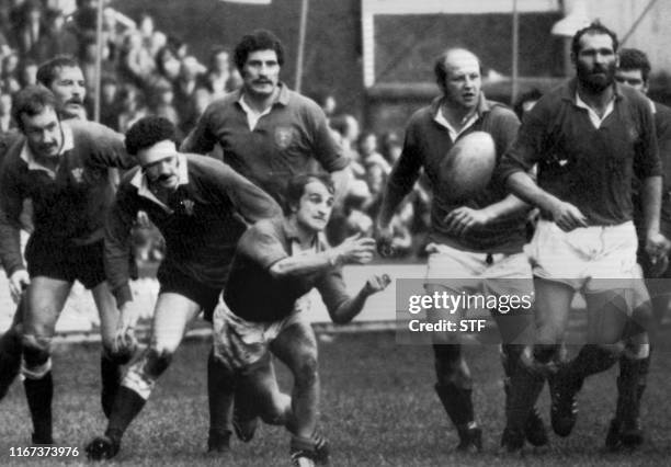 French Jacques Fouroux passes the ball in a Five Nations Tournament game opposing France to Wales in Cardiff 17 february 1974, while Wales' Jonathan...