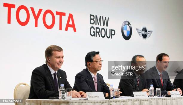 Toyota Motor executive vice president Takeshi Uchiyamada , accompanied by his senior staffs Yasumori Ihara and Didier Leroy , and BMW AG board member...